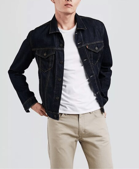 A man wearing a Rinse Levi’s Denim Trucker Jacket with a white t-shirt and khaki pants