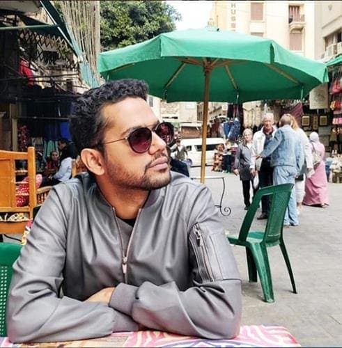 Pakistani rapper and influencer Ali Gul Pir enjoying the view at an outdoor cafe in Cairo, Egypt