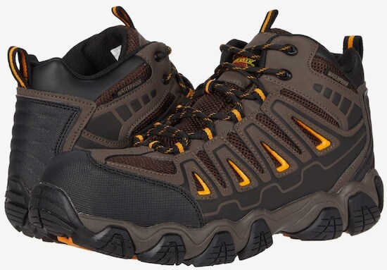 Men's Brown and Gray Merrell Hiking Shoes Holding Stick · Free Stock Photo