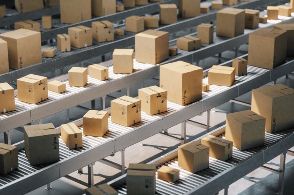 Rows of packages on conveyor belts in a shipping warehouse