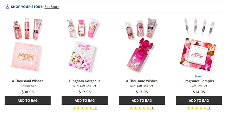 A screenshot of Bath & Body Work’s website showing 4 different pink gift box sets that consist of body lotions, mists, fragrances, and mini fragrance samples. There is a pink bag or box, and an “Add to bag” button under each gift set.