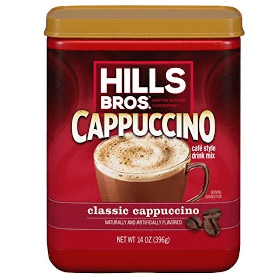 A red box of Hills Bros Instant Classic Decadent Cappuccino Mix with a tan lid and a cup of frothy cappuccino in front