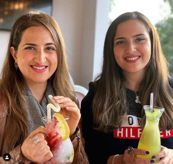 Egyptian influencers Aya and Alaa El Garhy enjoying cocktails