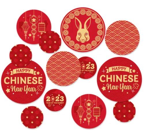 various sized circle shaped confetti with images of lanterns, rabbits, and greetings that read “Happy Chinese New Year.”