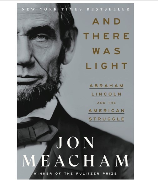 The black and white cover of Jon Meacham’s book titled And there was Light: Abraham Lincoln and the American Struggle, showing half of Lincoln’s face on the left