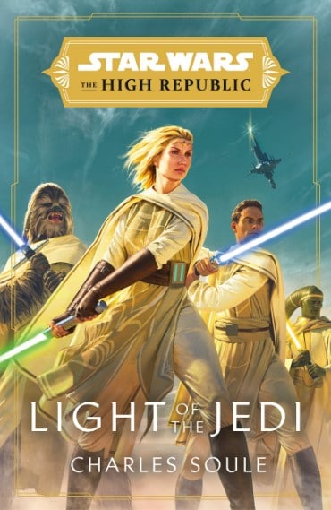 The cover of Charles Soule’s book “Light of the Jedi” with a blue, sky background, the two new main characters, Vernestra Rwoh and Avar Kriss, in the center, and Chewacca and a Twi'lek in the back, all dressed in gold and brown clothing. 