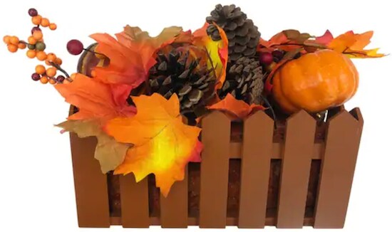 A brown wooden box that resembles a gate that carries a set of orange, red, yellow, and brown leaves, pumpkins, and pine cones from the Flora Harvest Decor Set