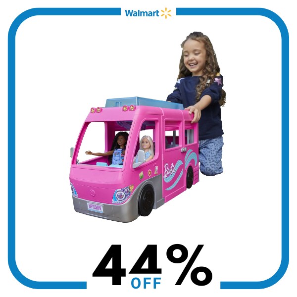 A girl playing with a pink toy van