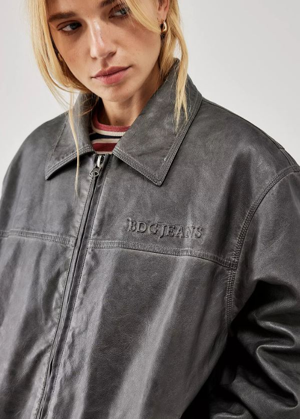 Model wearing oversozed Urban Outfitters faux leather jacket paired