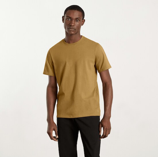 A man wearing a Hazel Everlane Organic Cotton Crew Shirt and a pair of black jeans