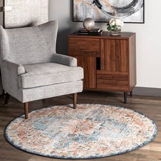 A small round medallion area rug placed in the corner of a living room