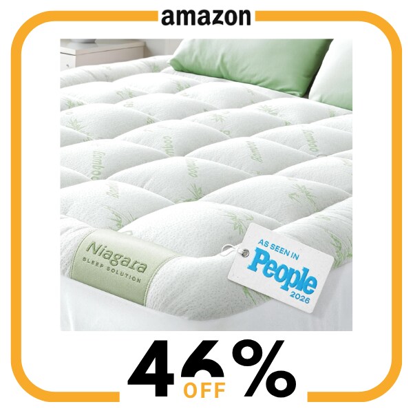 A white mattress topper on a mattress