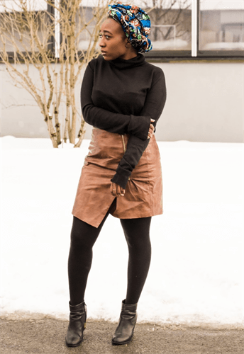 Influencer Jocelyne Nkiambi wearing brown leather skirt and floral head wrap