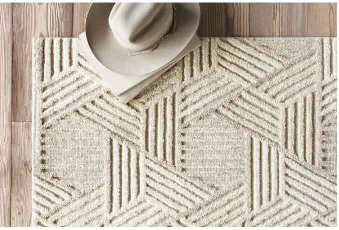 Beige geometric-patterned rug with a beige hat on it