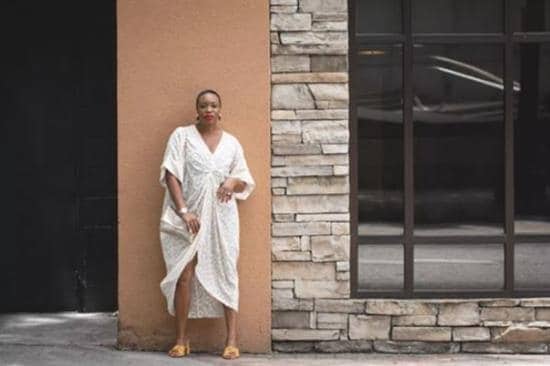 Caribbean influencer Ianthia Ferguson posing in a white dress in Atlanta, GA