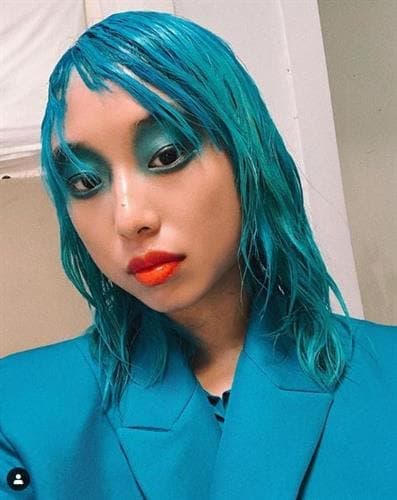 Australian born influencer Margaret Zhang striking a pose in all blue with coral lips