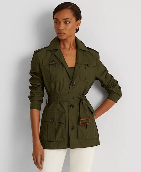 A woman wearing a Dark Tropical Olive Lauren Ralph Lauren Belted Twill Field Jacket with an olive shirt and white pants