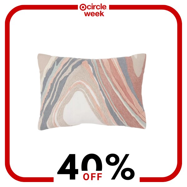 A pink blue and white decorative pillow