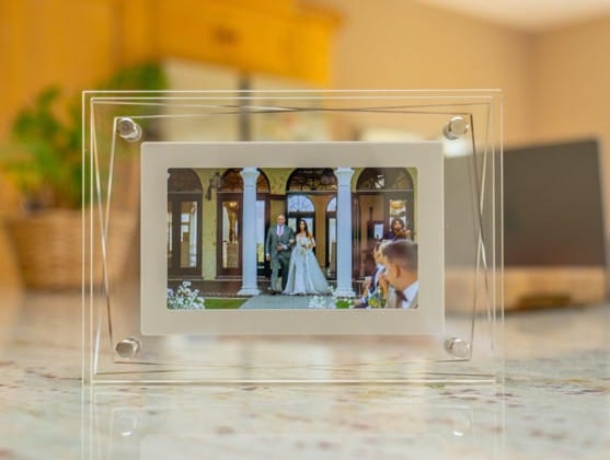 Transparent digital photo frame displaying a wedding photo