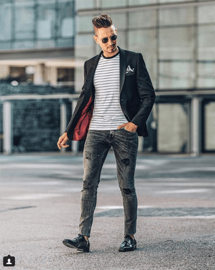 Influencer Sergio Ines walking on a South African street in black blazer and black oxfords