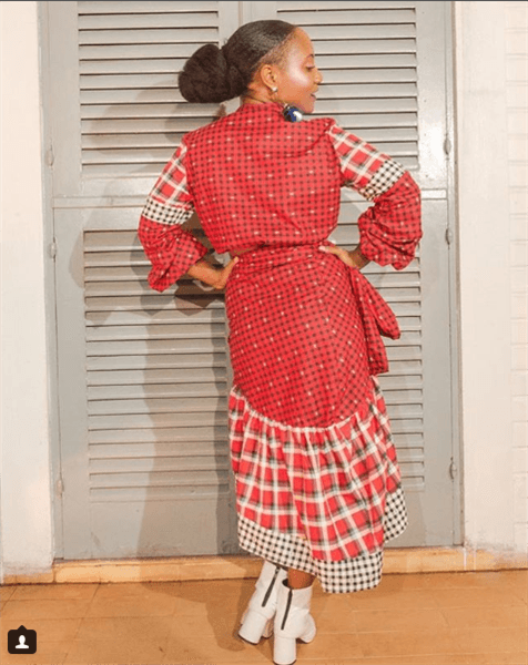 Influencer Luiza Brasil wearing red plaid and polka dotted dress and white leather booties