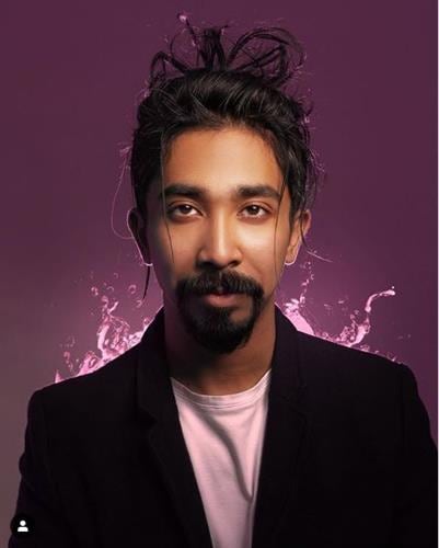 Portrait of Bahraini influencer Salah Abdulmajid against a purple background