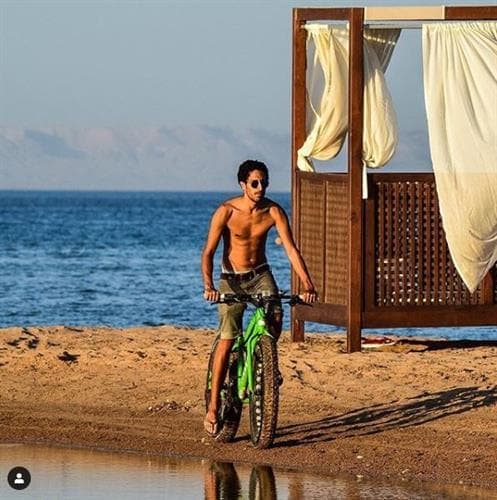 Guinness World Record holder Helmy Elsaeed on a bike on the beach
