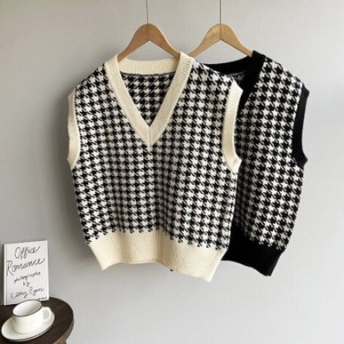Black and white Madame Lorraine Dark Academia Sweater Vests on hangers