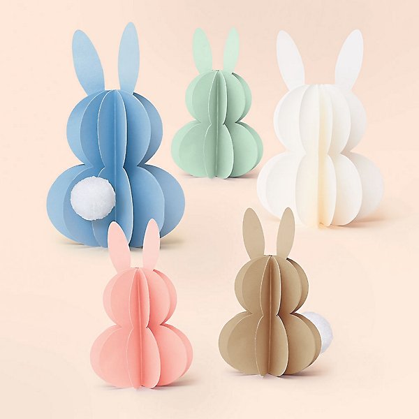paper cut out of a blue, white, green, pink, and brown bunnies for Easter
