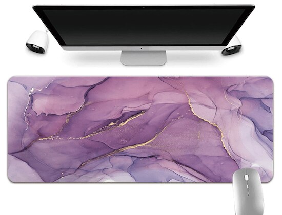 A purple findingcaseuk Printed Watercolor Anti-Slip Leather Waterproof Desk Mouse Pad in the middle of an Apple Desktop, two white speakers, and a silver mouse.