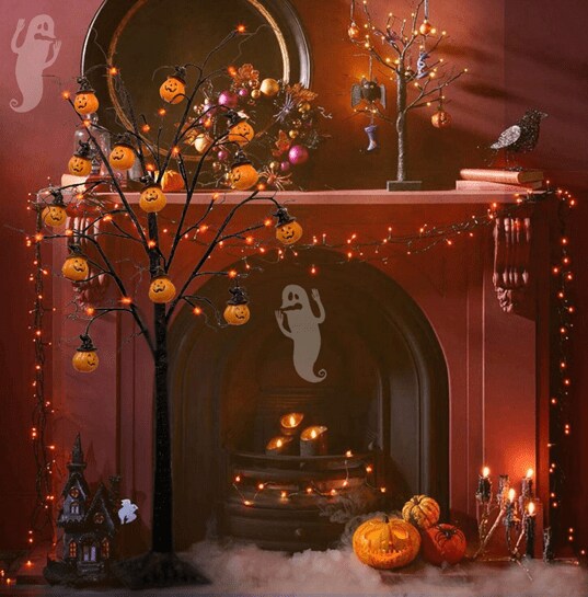 A red fireplace decorated with Twinkle Star’s 4 ft. spooky tree with pumpkins and led lights