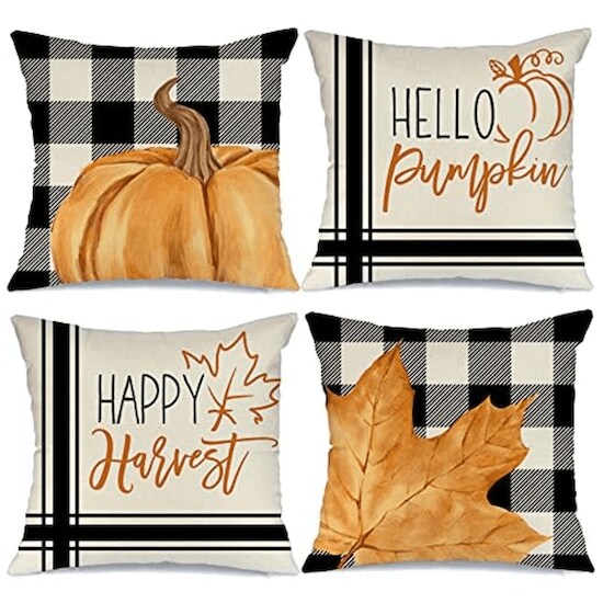 Four throw pillows with GEEROY Fall Pillow Covers that sport white and black checker patterns, stripes, orange leaves and pumpkins, and black and orange words