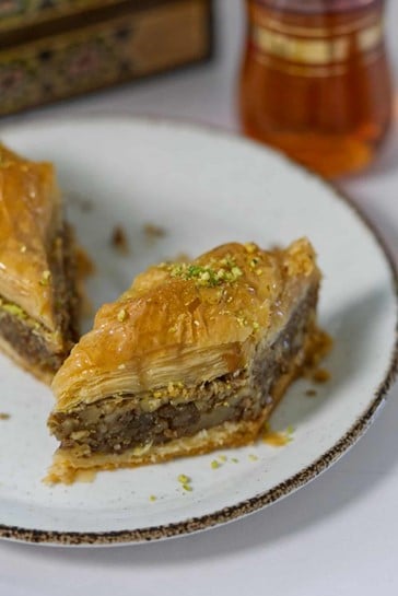 two slices of baklawa on a white plate