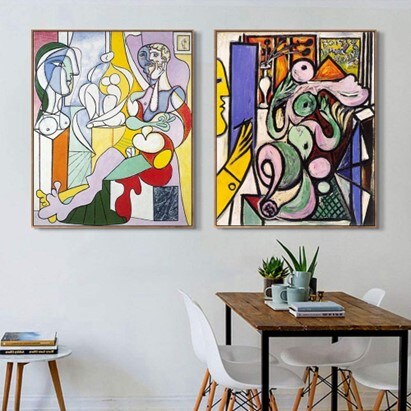 Two framed cubist Picasso prints hanged on a white wall
