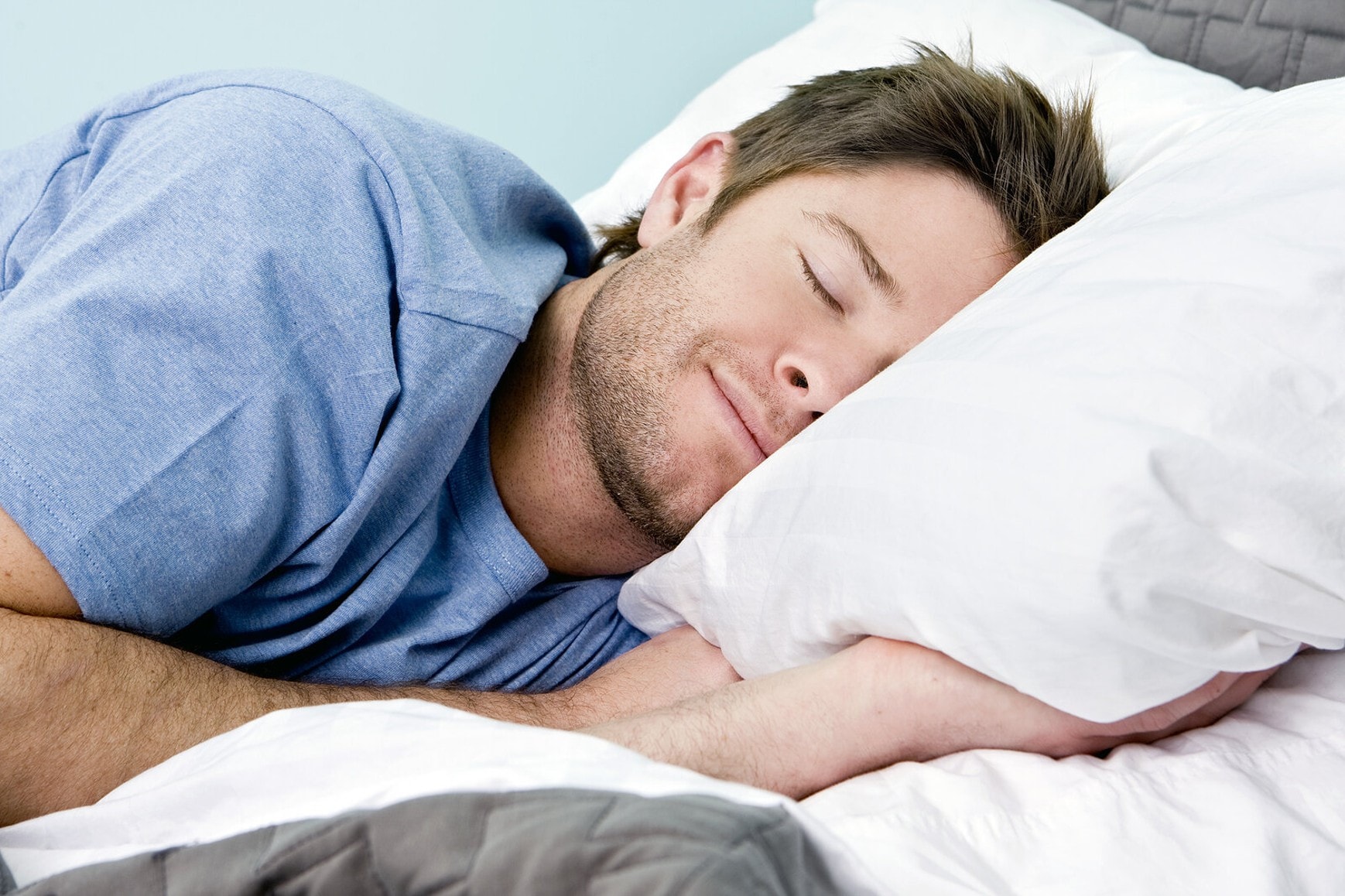 Man sleeping comfortably in bed