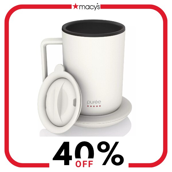 A white warming coffee mug with a base and lid