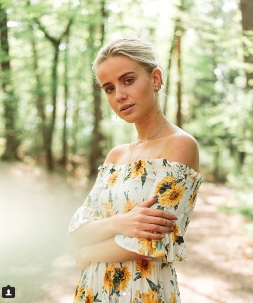 Influencer Anniken Jorgensen in forest wearing sunflower off the shoulder dress 