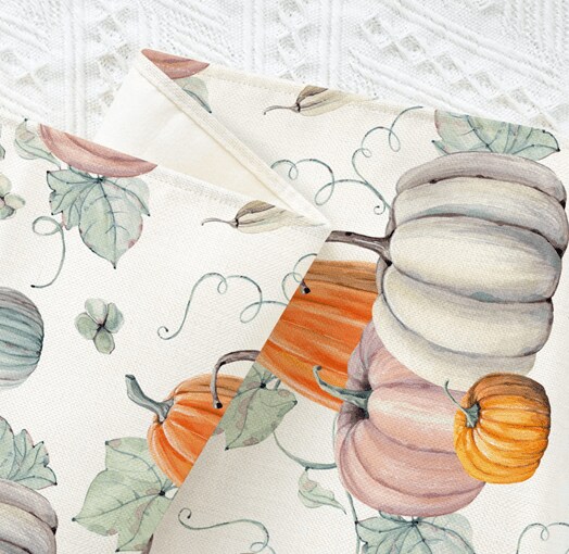 A close-up of Sambosk’s gray table runner with orange and gray pumpkins
