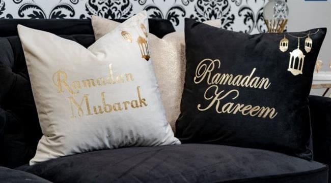 Black and white pillow cases stating Ramadan Kareem and Ramadan Mubarak