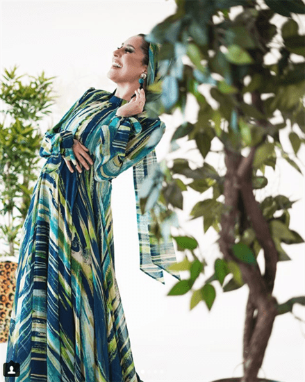Blogger Dina Torkia wearing green and blue patterned dress with matching hijab