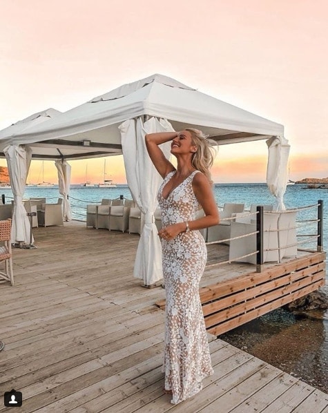 Influencer Sendi Skopljak in floor length lace dress on lake deck