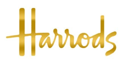 The Harrods logo written in cursive gold letters on a white background