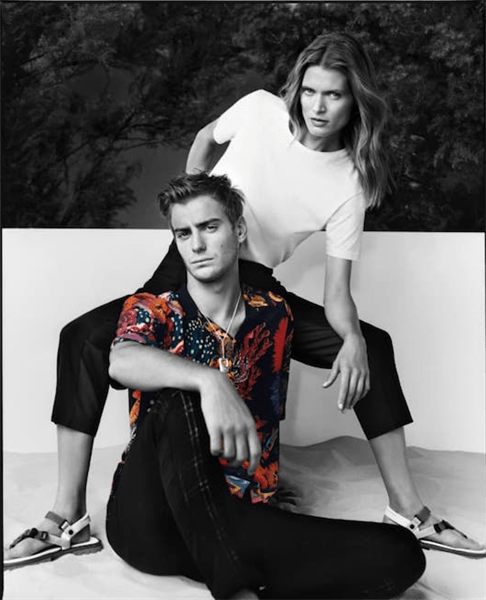 Male wearing colorful shirt sitting in front of female posing