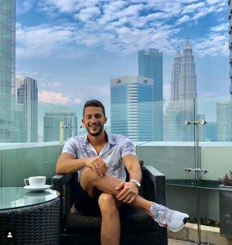 Egyptian blogger and brand ambassador Mohamed Farag sitting in front of a skyline
