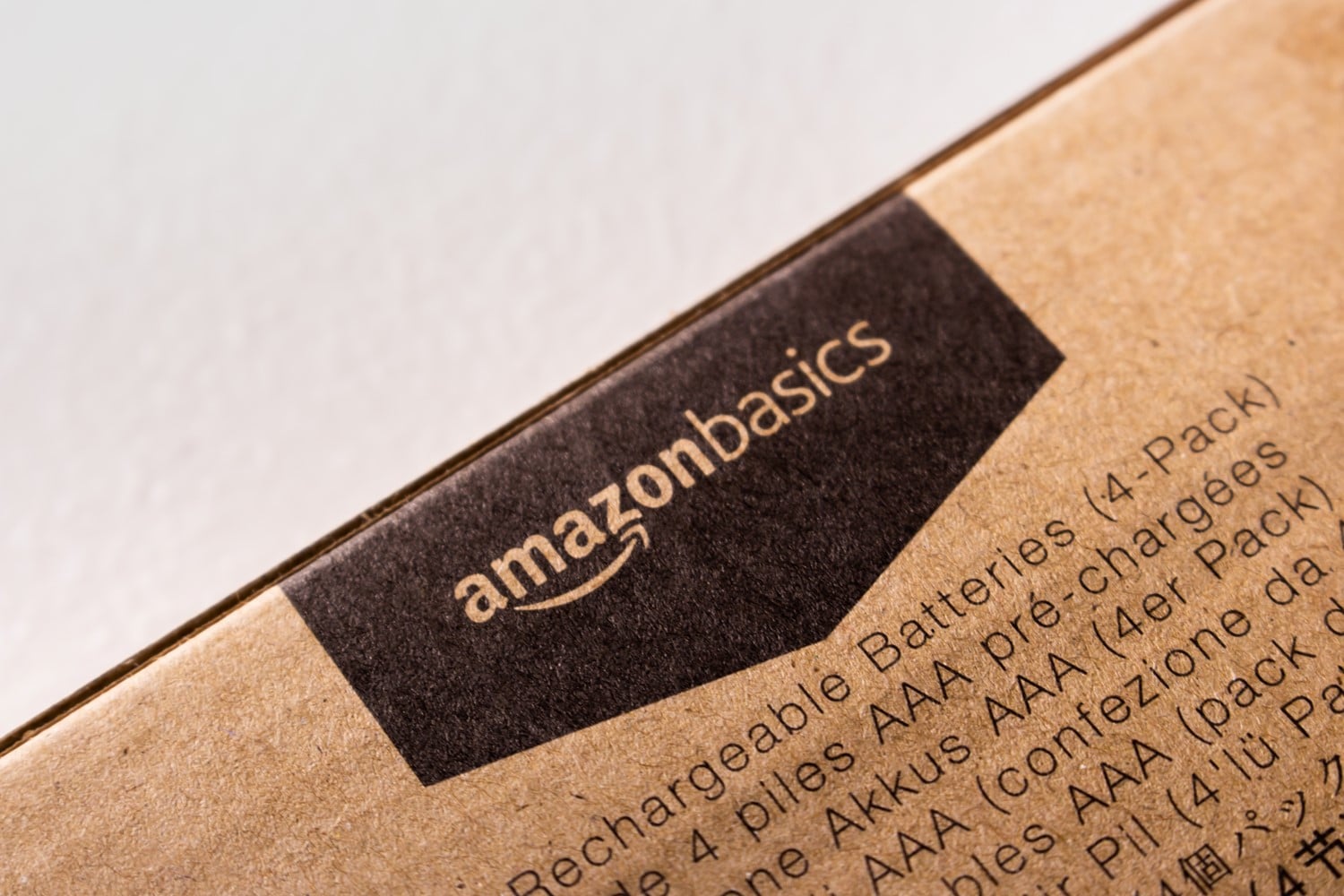 Close up on one edge of a boxed package. There is a AmazonBasics logo on the edge of the box. 