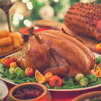 image of holiday ham, turkey, and a side dish for a holiday meal
