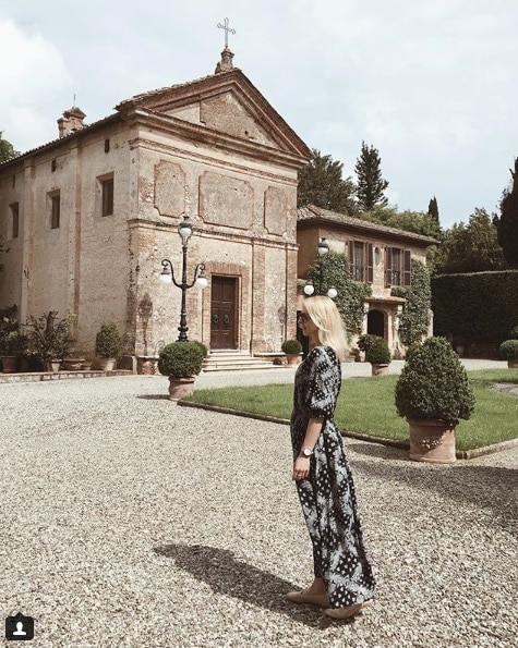 Influencer Matylda wearing floor length dress in front of a church