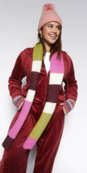 woman wearing red velvet jumpsuit with a pink beanie and multicolored scarf from forever 21
