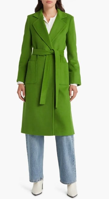 Model wearing the clover green wool-coat from Nordstrom, paired with straight light blue jeans and white boots