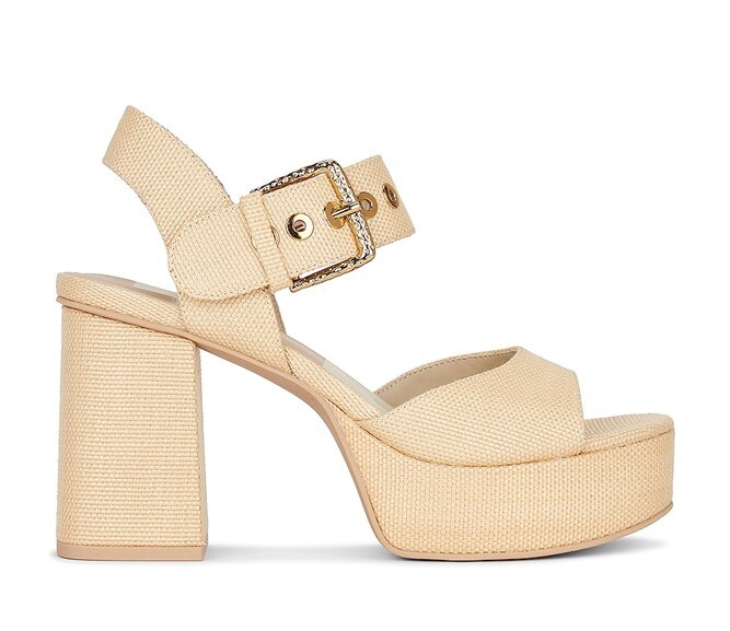 A side view of a beige Dolce Vita Bobby heel with an adjustable buckle strap